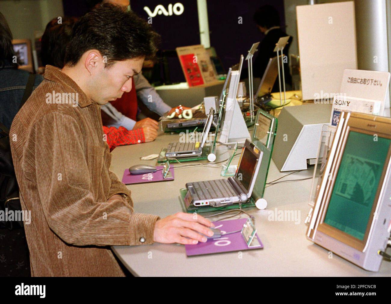 A visitor to a Tokyo showroom of Sony Corp., examines its Vaio personal ...
