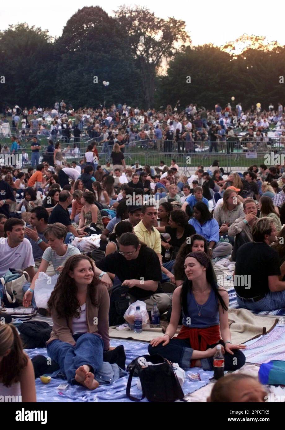 People wait on blankets on the lawn of New York's Central Park for the  start of the "Sheryl Crow and Friends" concert Tuesday, Sept. 14, 1999.  Among Crow's friends performing in the