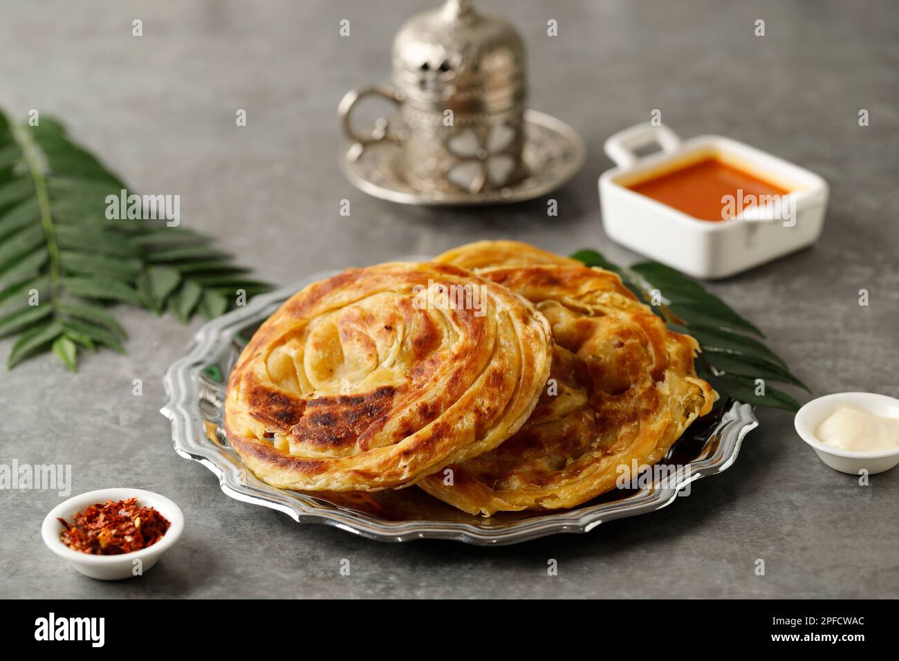 Roti Parata or Roti Canai with Chicken Curry Sauce, Popular Malaysian