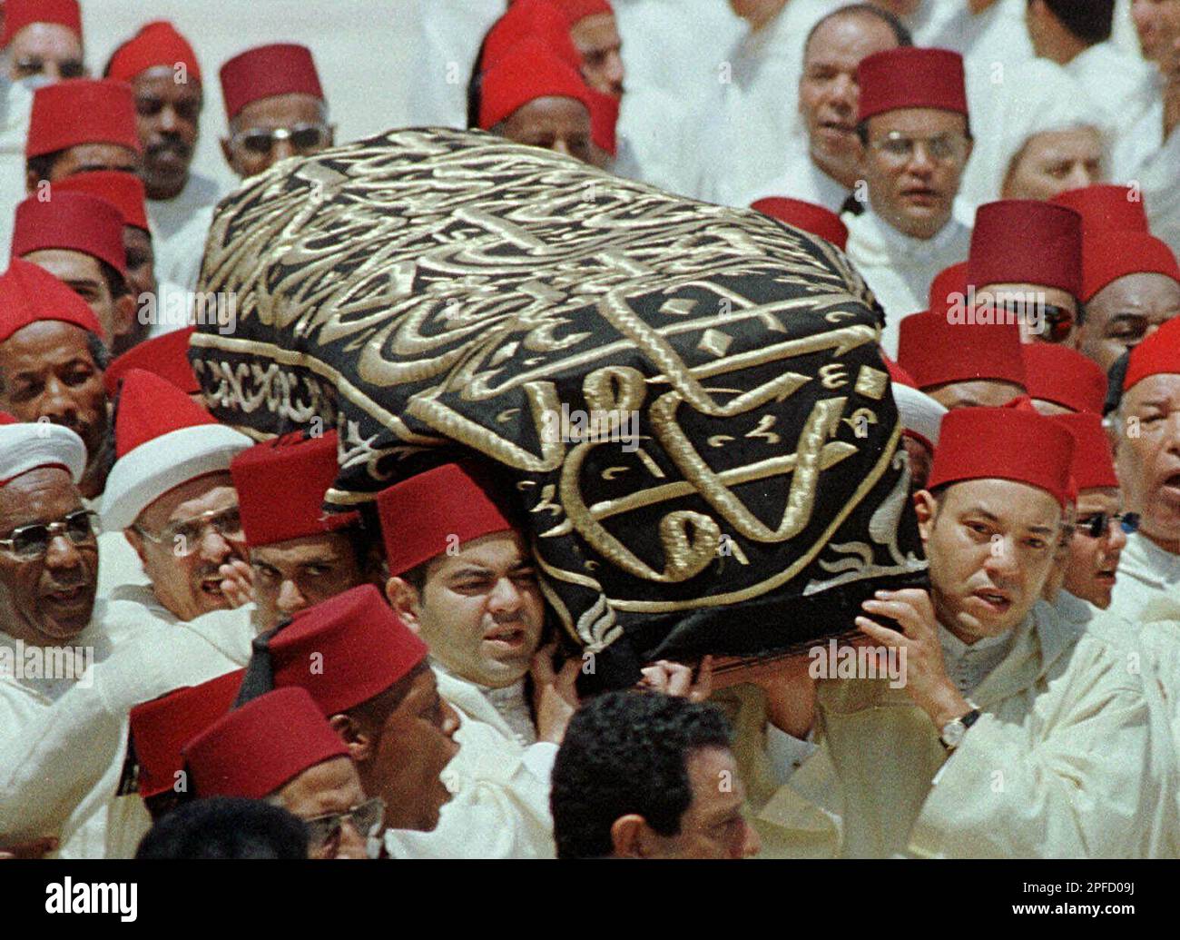 King Mohamed VI, right, and his brother Moulay Rachid, left, carry the ...
