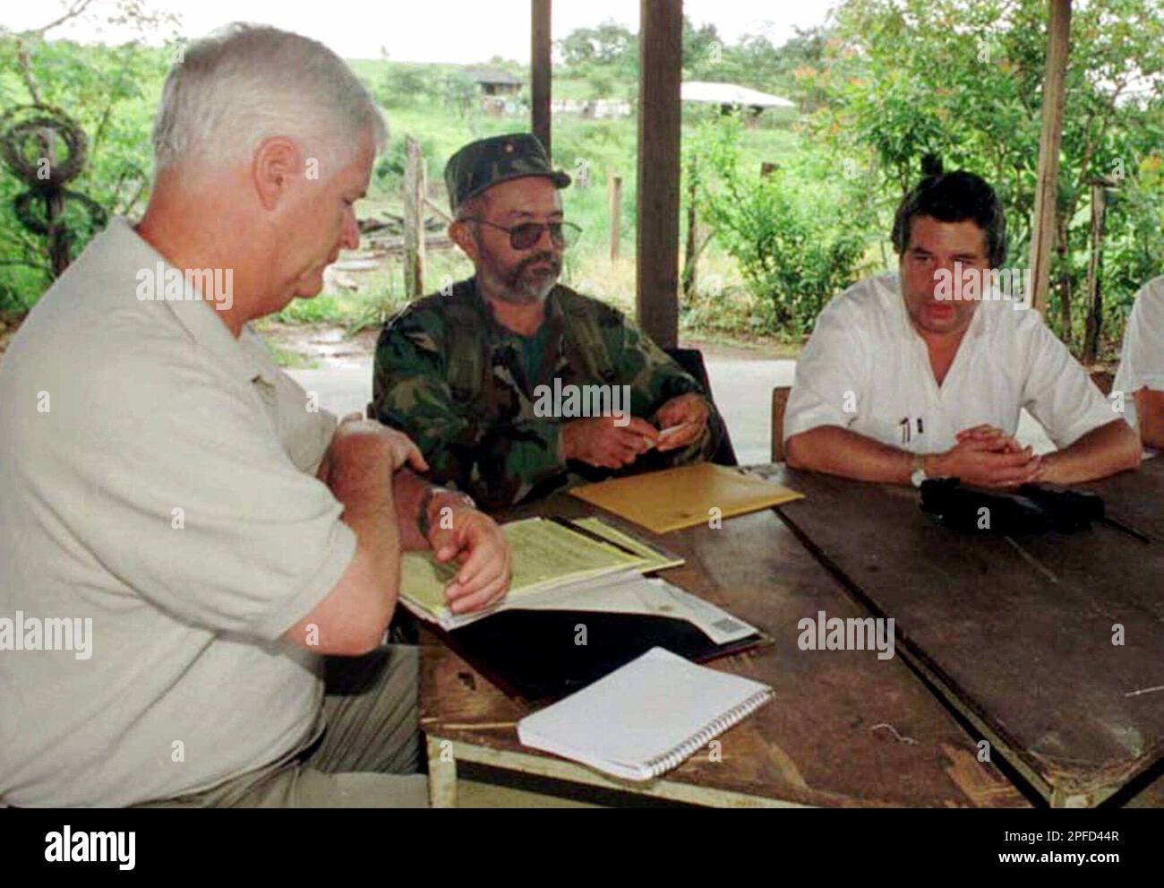Rep. William Delahunt, D-Mass., left, and rebel commander Raul Reyes,  center, of the Revolutionary Armed Forces of Colombia (FARC), and peace  commissioner Victor Ricardo, right, meet Thursday, June 3, 1999, in the