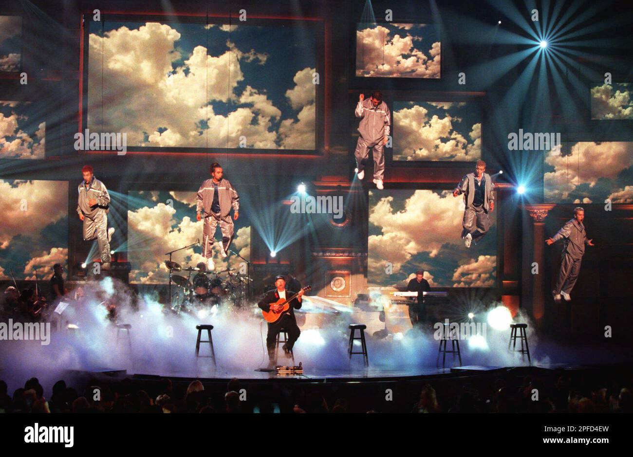 The five members of vocal group 'N Sync are lifted into the air by wires as they perform with