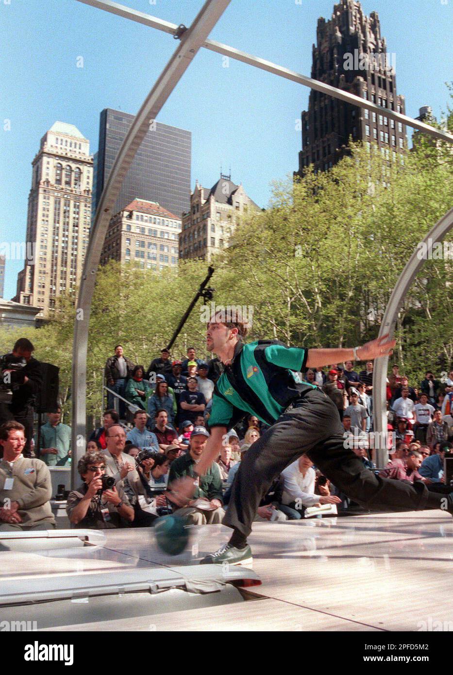 With the New York City skyline as a backdrop, Mark Mosayebi of Charlotte, N.C., bowls during the first-ever outdoor bowling tournament hosted by the Professional Bowlers Association in New Yorks Bryant Park,