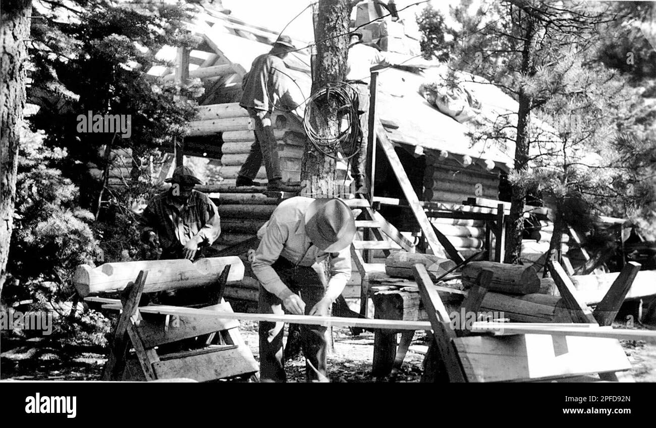 Civilian Conservation Corps workmen building cabins in the 