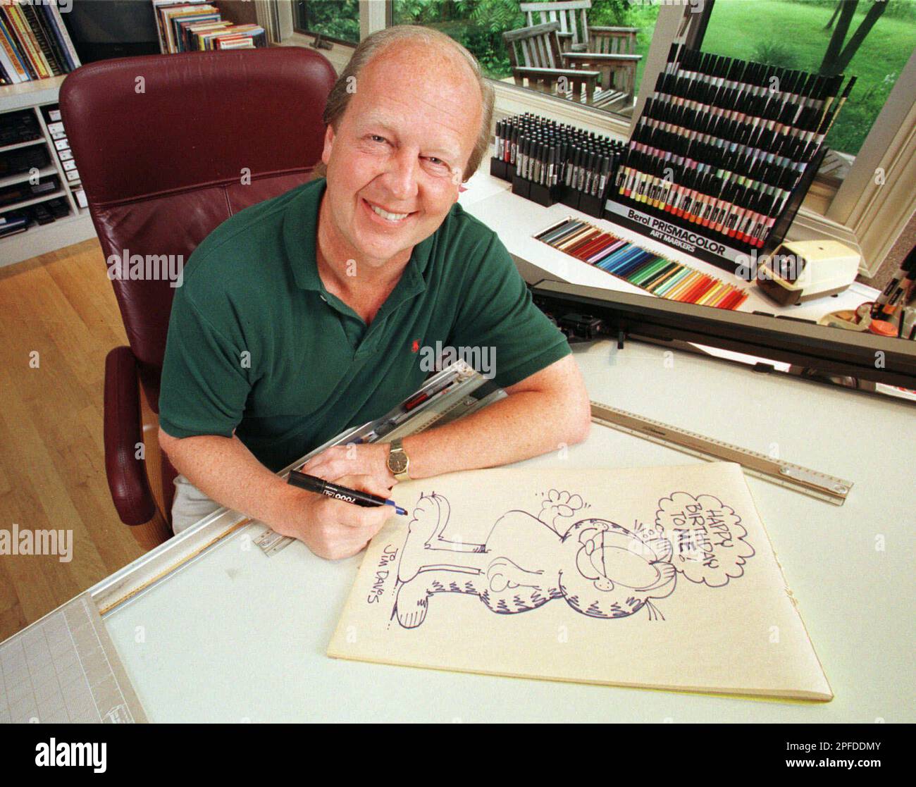 Garfield creator Jim Davis, pauses after drawing the cartoon character ...