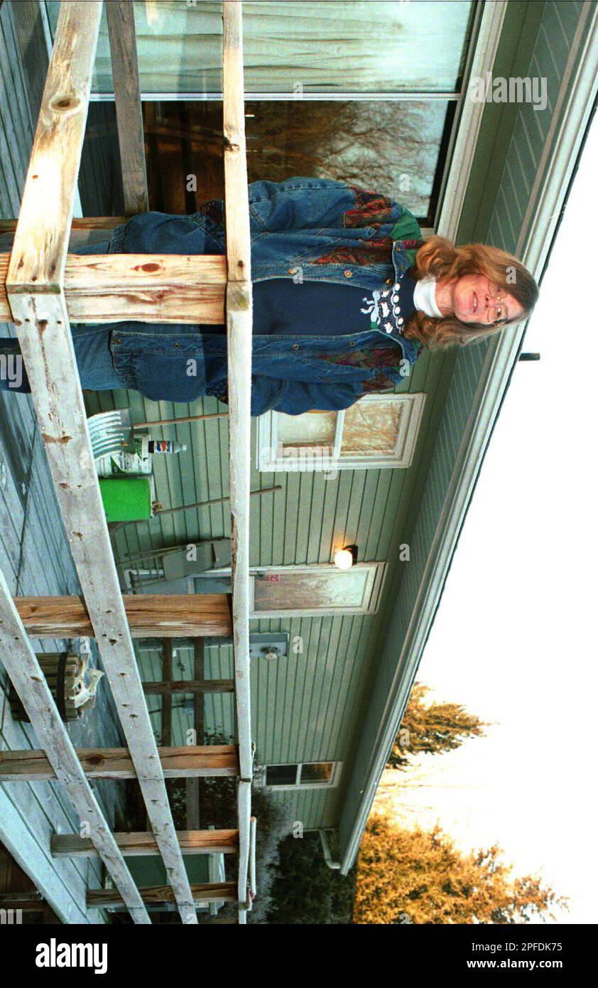 Shirley Allen, 51, of Roby, Ill., stands on the back porch of her