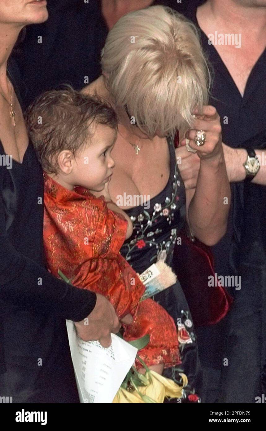 Paula Yates bows her head in grief while holding her daughter Heavenly  Hiraani Tiger Lily leaves the funeral of her lover Michael Hutchence,  Thursday, November 27, 1997, in Sydney, Australia. (AP Photo/Rick