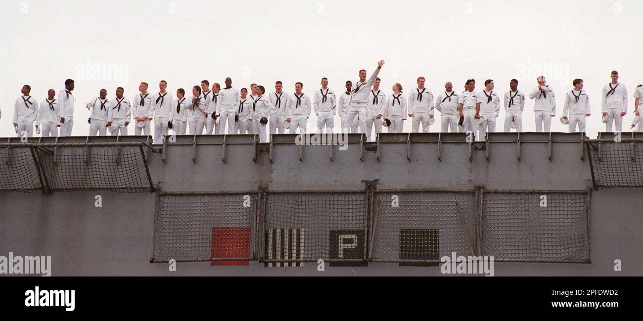 A lone sailor breaks ranks to give a wave upon the homecoming of the  aircraft carrier John F. Kennedy at Mayport Naval Station in Jacksonville,  Fla., Tuesday, October 28, 1997. The ship