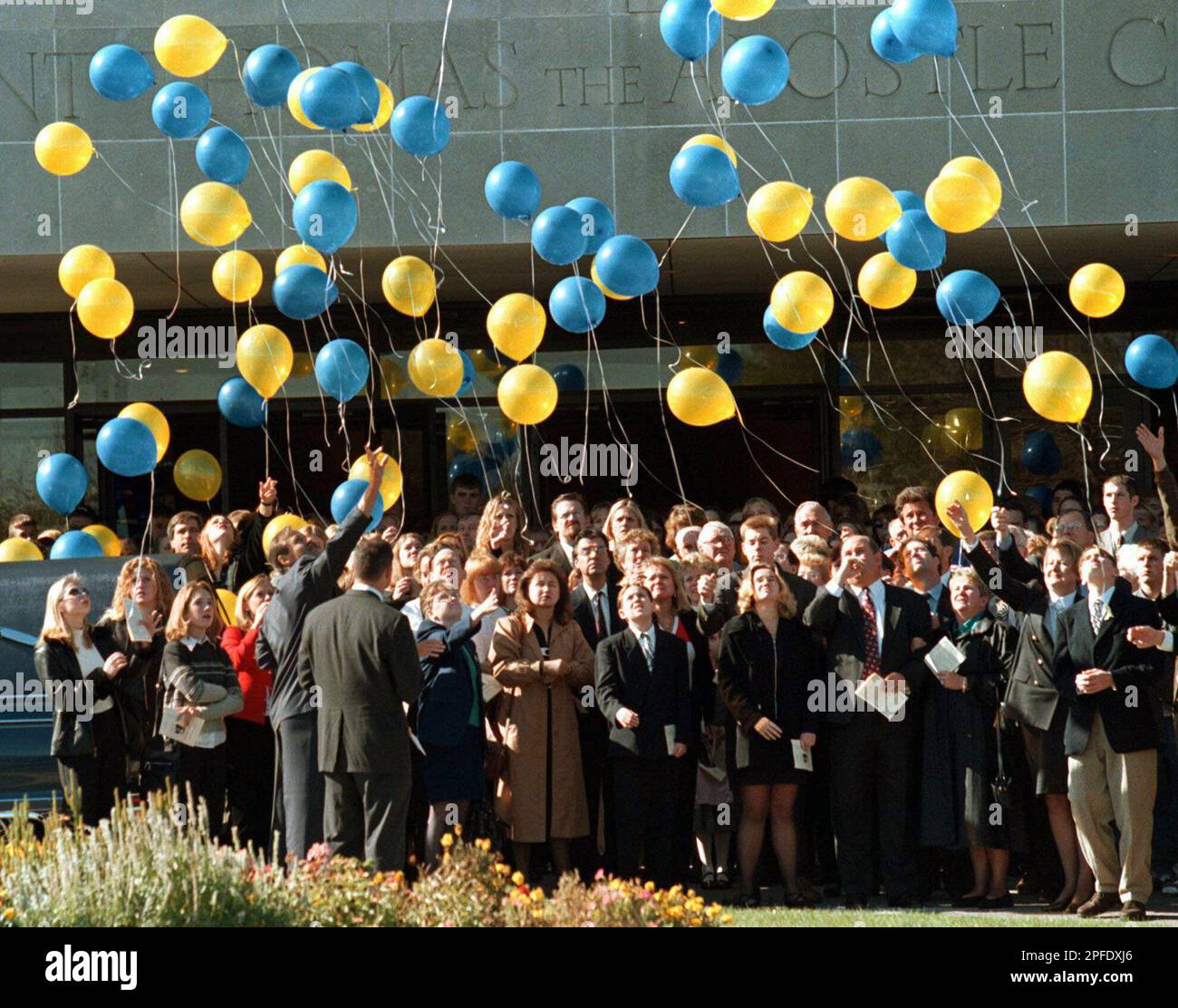Mourners release balloons outside Saint Thomas the Apostle Church in