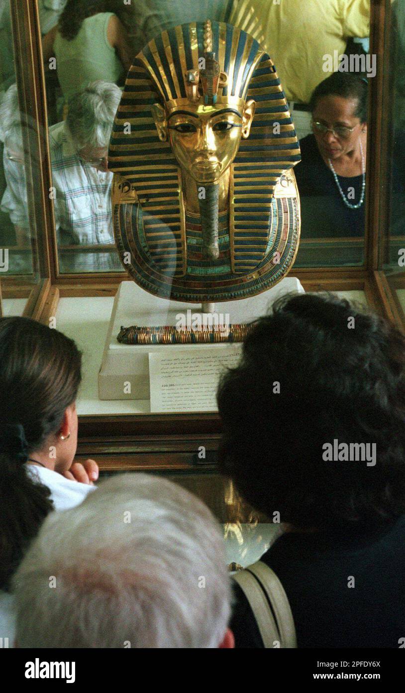 Tourists look at the golden mask of King Tutankhamen in Cairo's ...