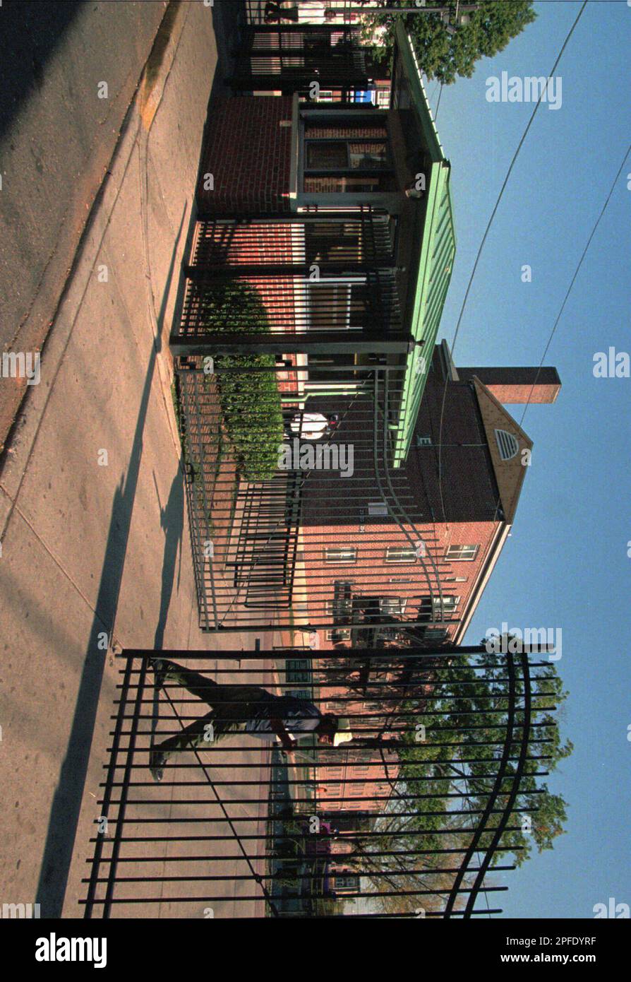 A man walks past the gated entrance to the Pioneer homes public housing