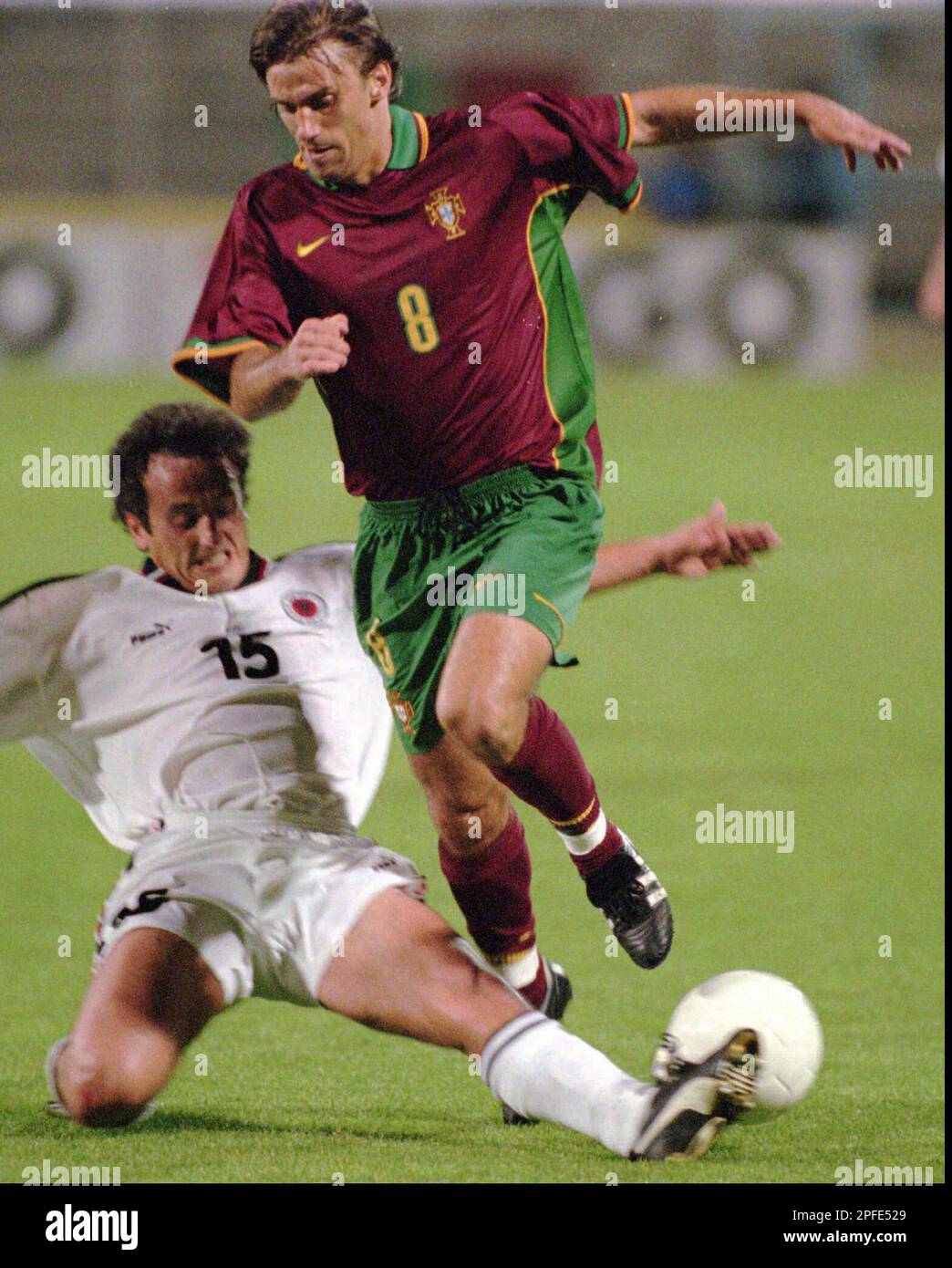 Portuguese striker Joao Pinto (right) is tackled by an