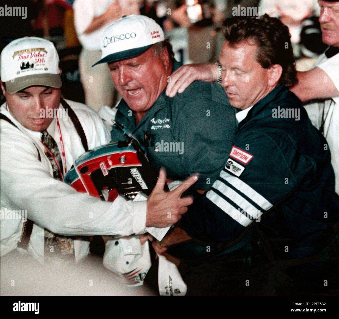 Texas Motor Speedway personnel pull A.J. Foyt, center, away from Indy ...
