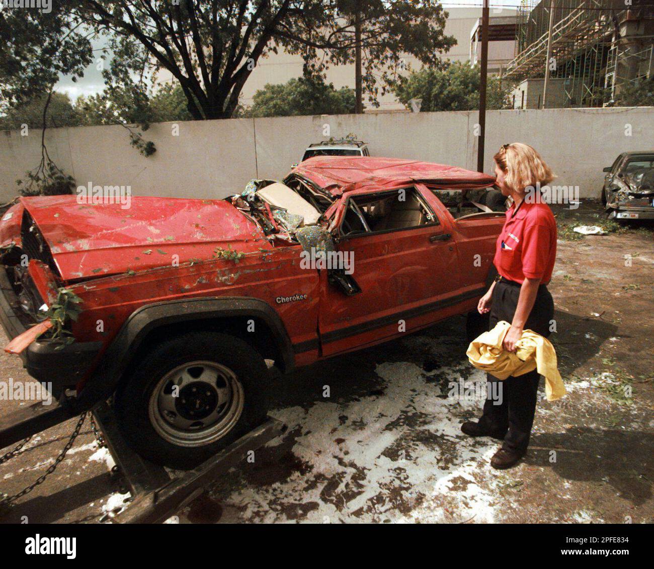Jeanne Maxfield looks at her vehicle after it was rolled by a tornado which  touched down in the southwest edge of Miami, Monday, May 12, 1997. (AP  Photo/Rick Bowmer Stock Photo - Alamy
