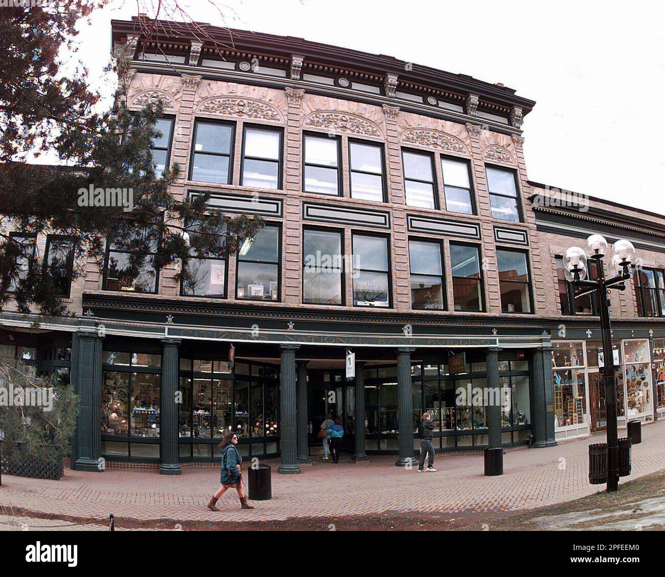 Pedestrians walk past the historic Citizens Bank Building