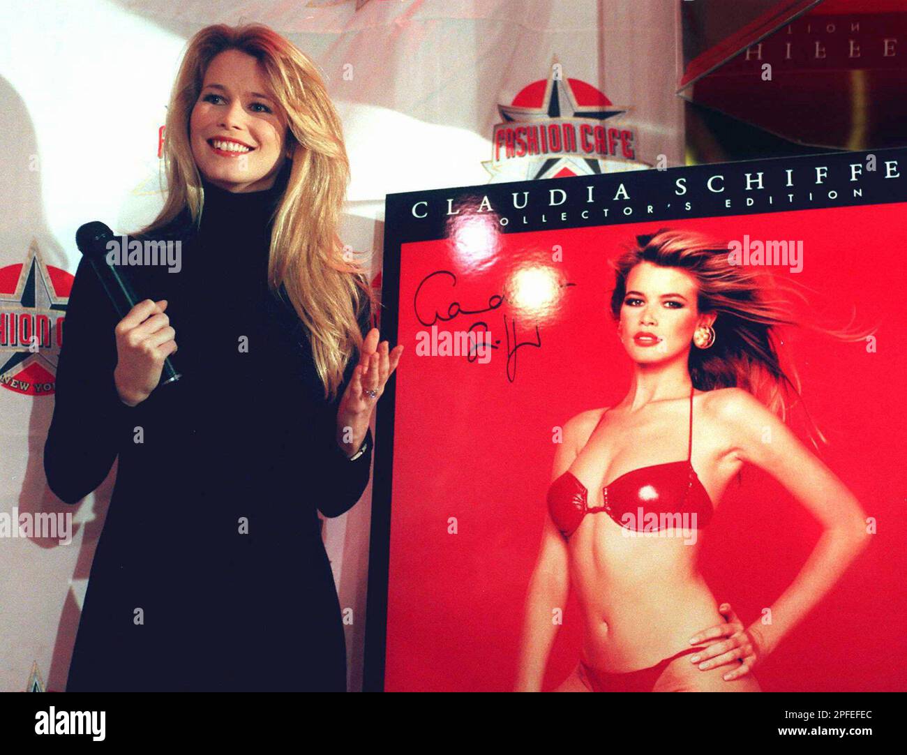 Claudia Schiffer poses next to her 1997 calendar during a news 