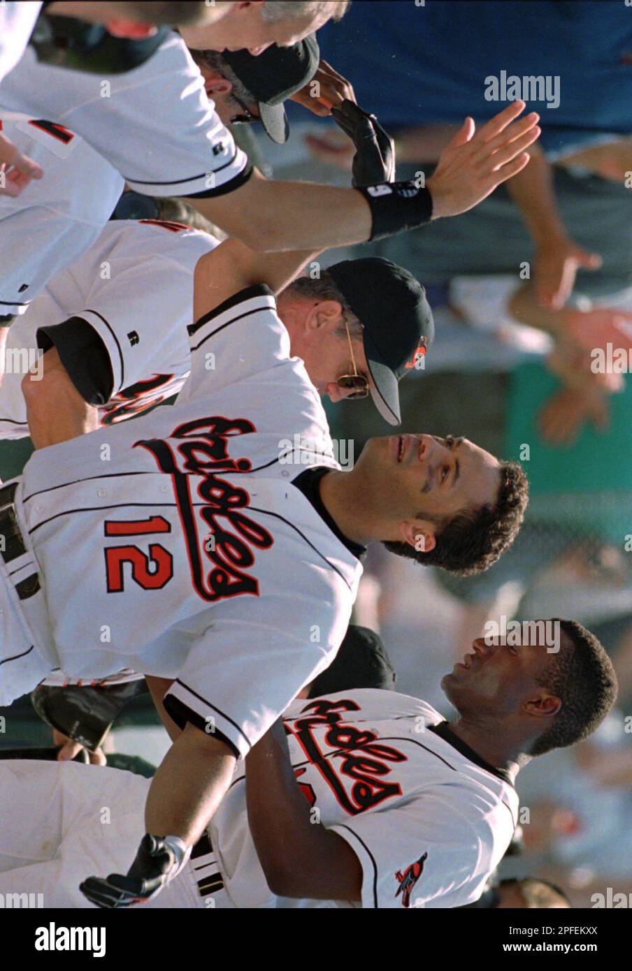Baltimore Orioles Roberto Alomar, left, is congratulated by teammate Brady  Anderson as they return to the dugout after Alomar hit a two-run home run  with Anderson aboard in the third inning against