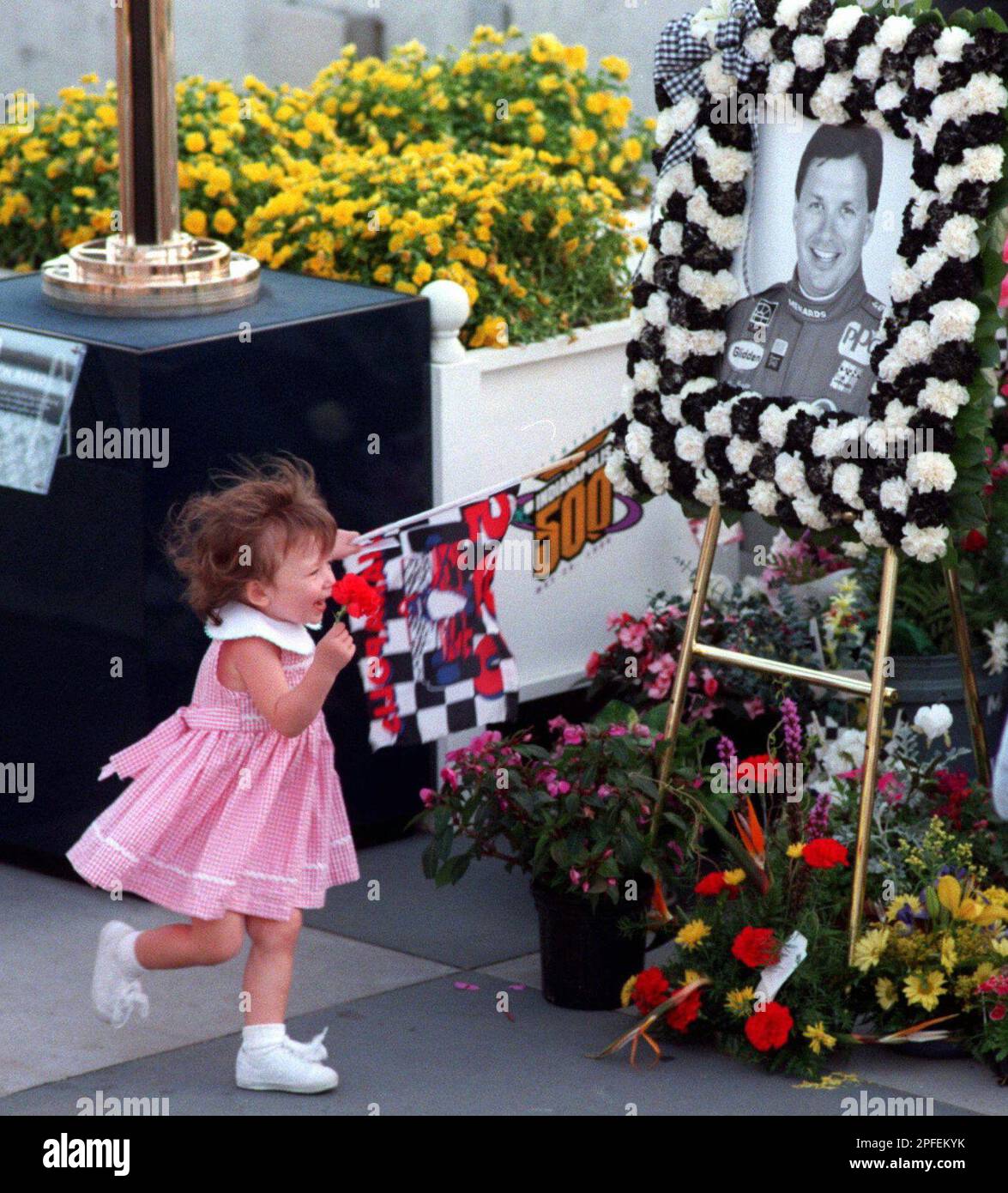 https://c8.alamy.com/comp/2PFEKYK/two-year-old-carly-brayton-runs-toward-a-picture-of-her-father-scott-during-a-memorial-service-at-the-indianapolis-motor-speedway-saturday-may-18-1996-when-the-track-closed-for-the-day-after-qualifications-brayton-was-killed-friday-when-his-backup-car-crashed-into-the-turn-two-wall-ap-phototom-strickland-2PFEKYK.jpg