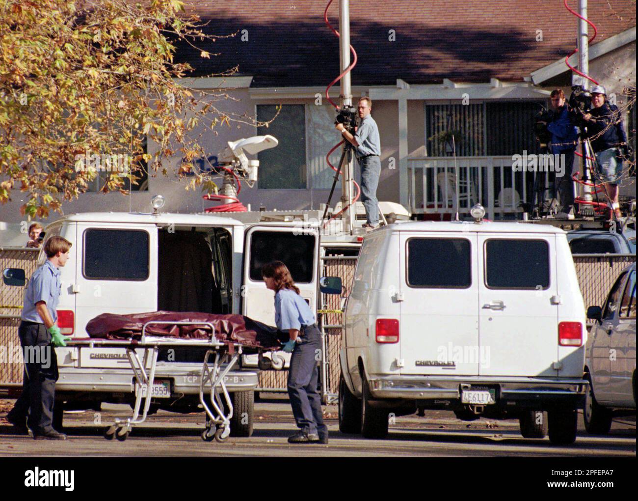 Workers from the San Diego County Coroners Office remove one Workers from the San Diego County Coroners Office remove one