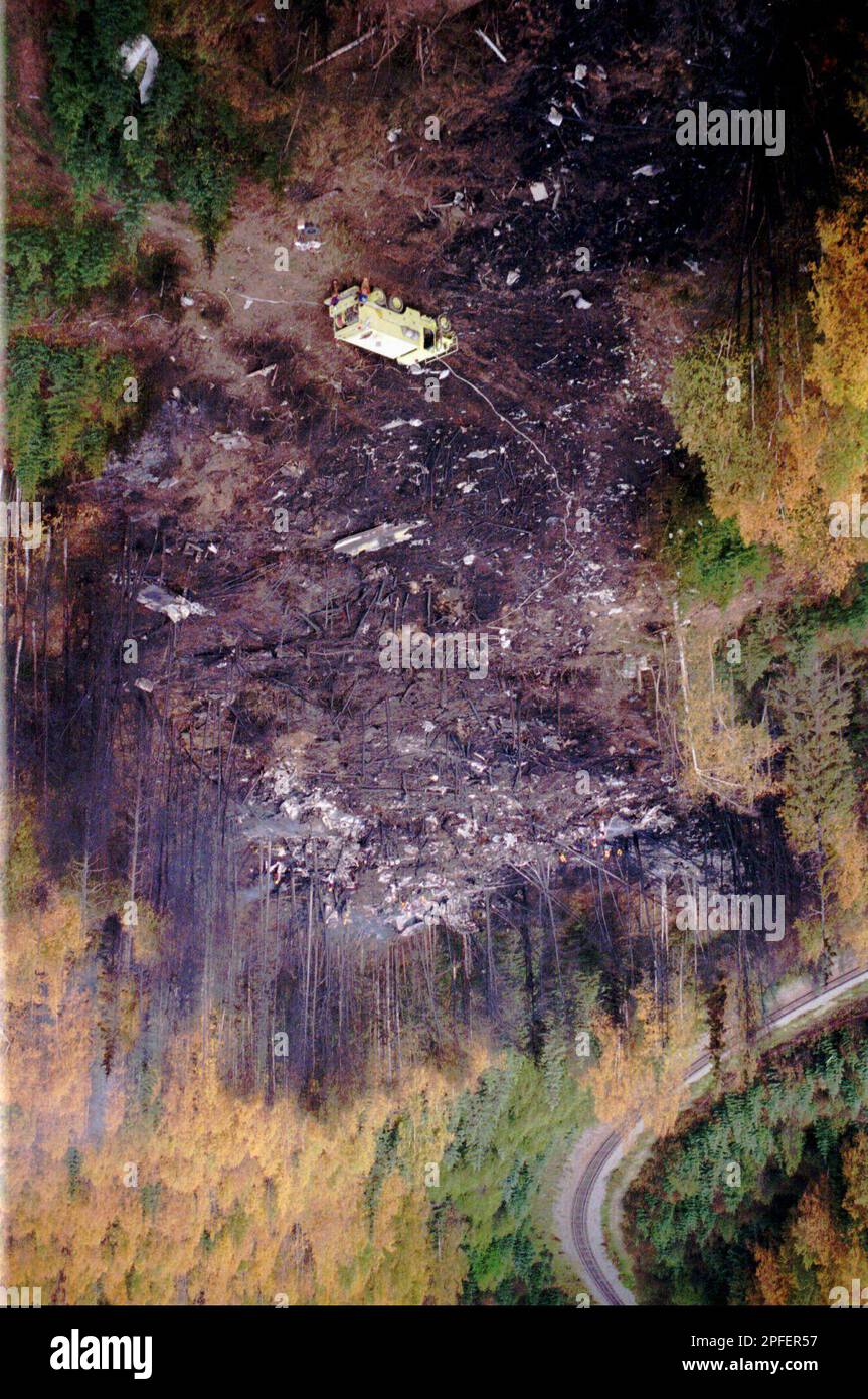 Air Force rescue personnel work at the site of the crash of