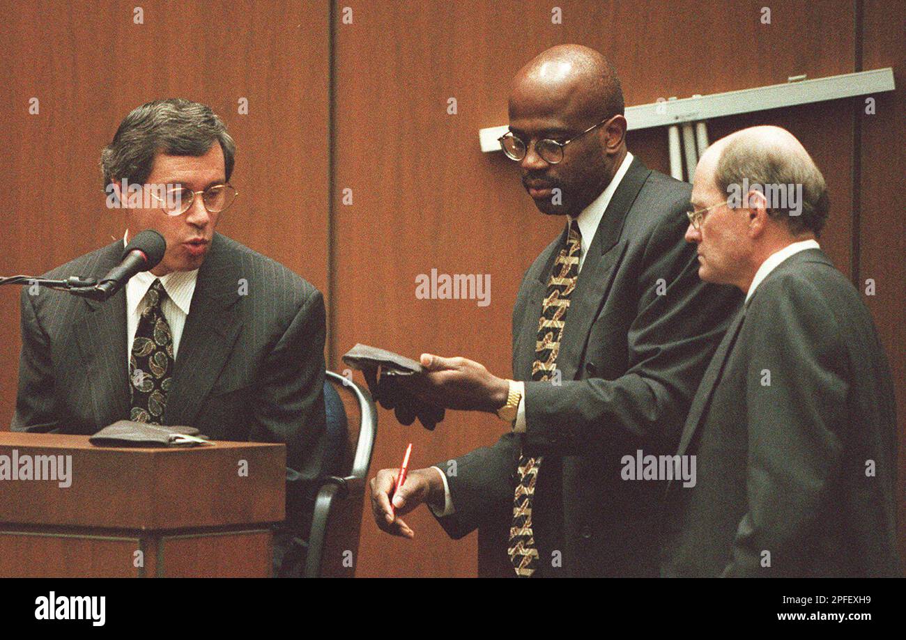 Prosecutor Christopher Darden, center, holds a pair of gloves for glove