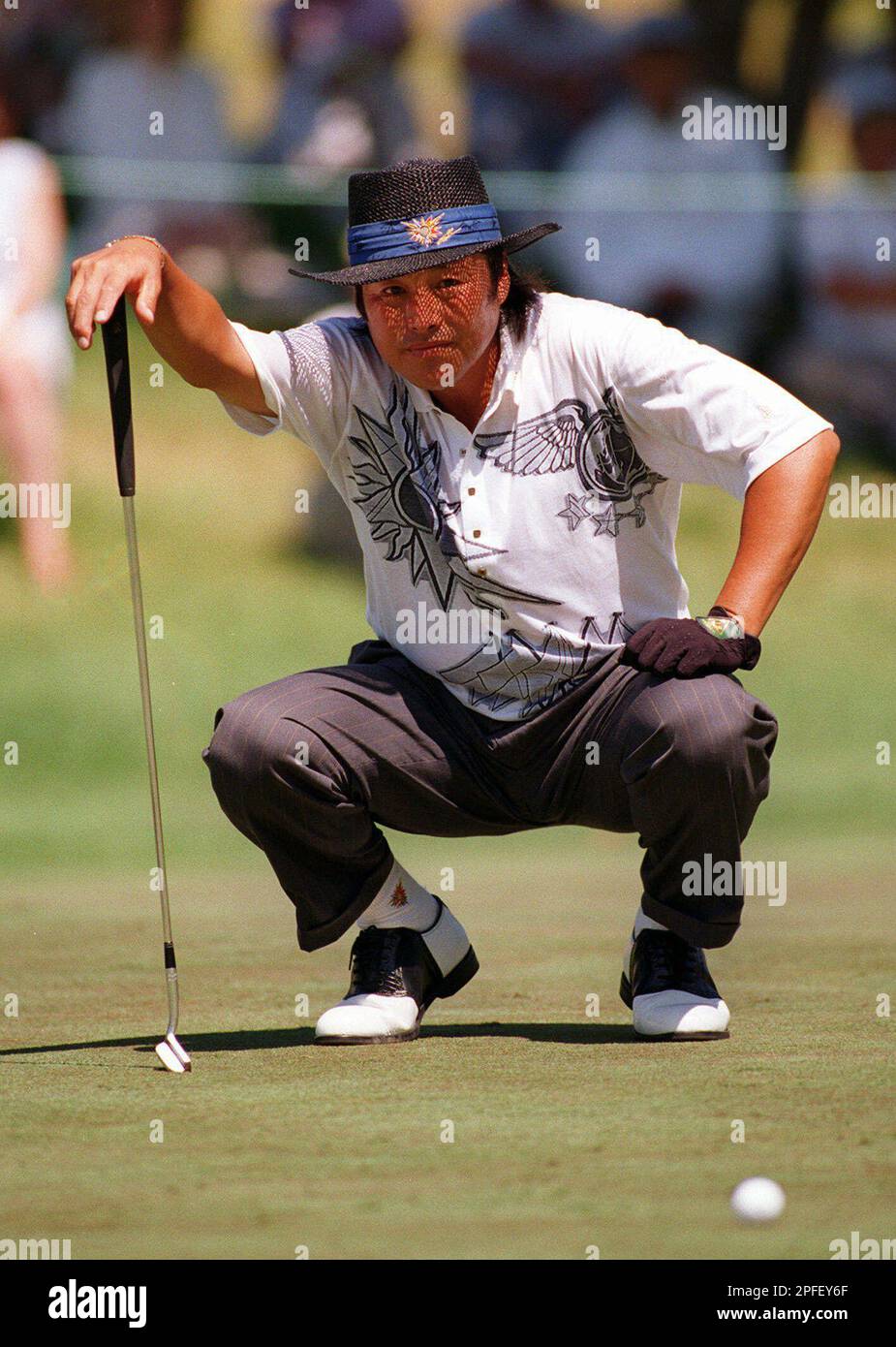 Jumbo Ozaki of Japan lines up a putt on the ninth hole during the