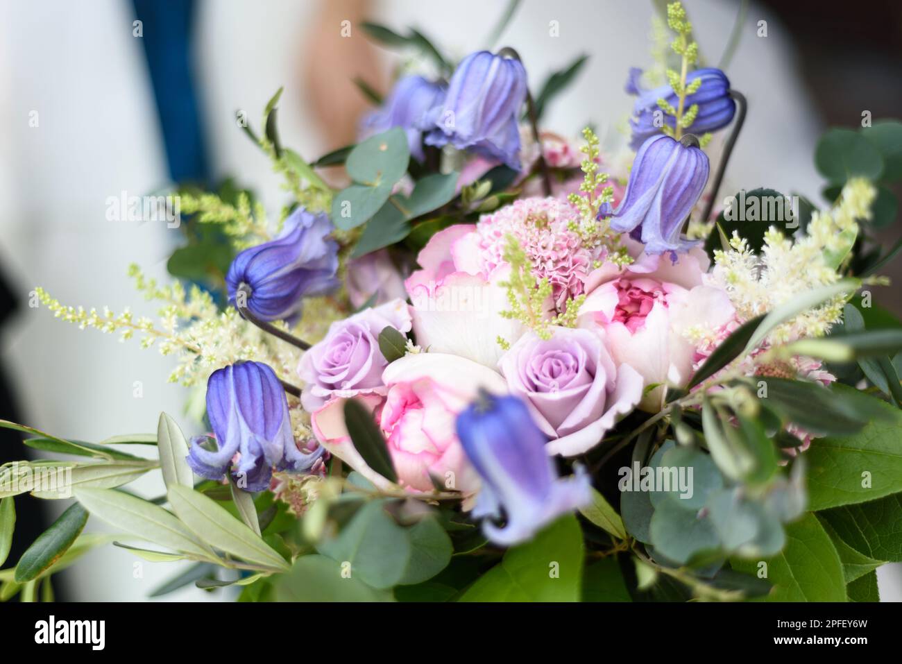 Wedding bouquet with blue and purple flowers and pink roses. Stock Photo