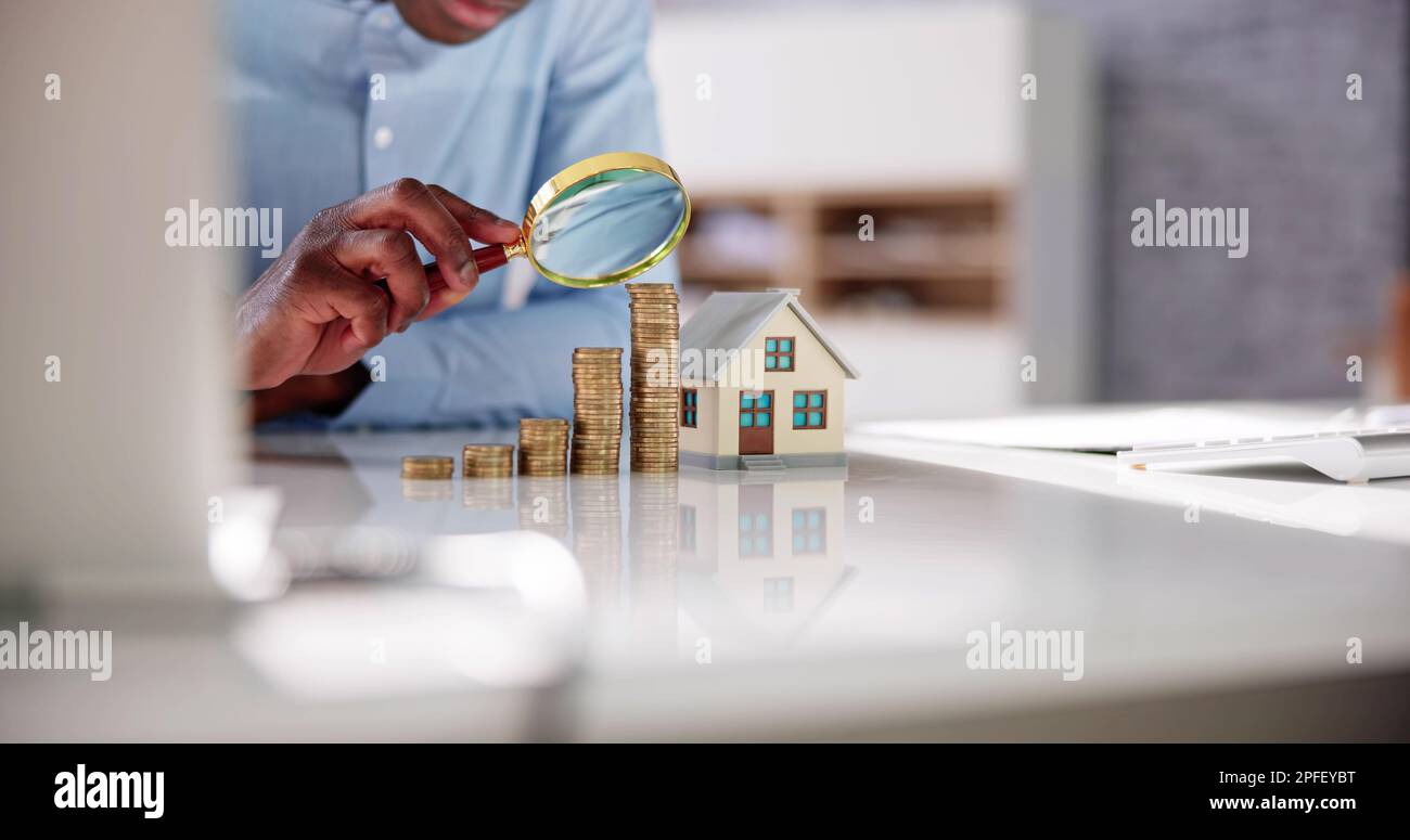 Saving Money For House. Using Magnifying Glass Stock Photo