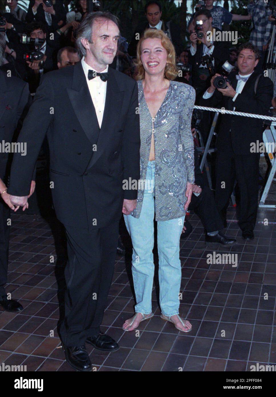 British film star Emma Thompson wears sandals and jeans as she arrives with  co-star Welsh actor Jonathan Pryce at the Festival Palace in Cannes, French  Riviera on Sunday May 21, 1995, to