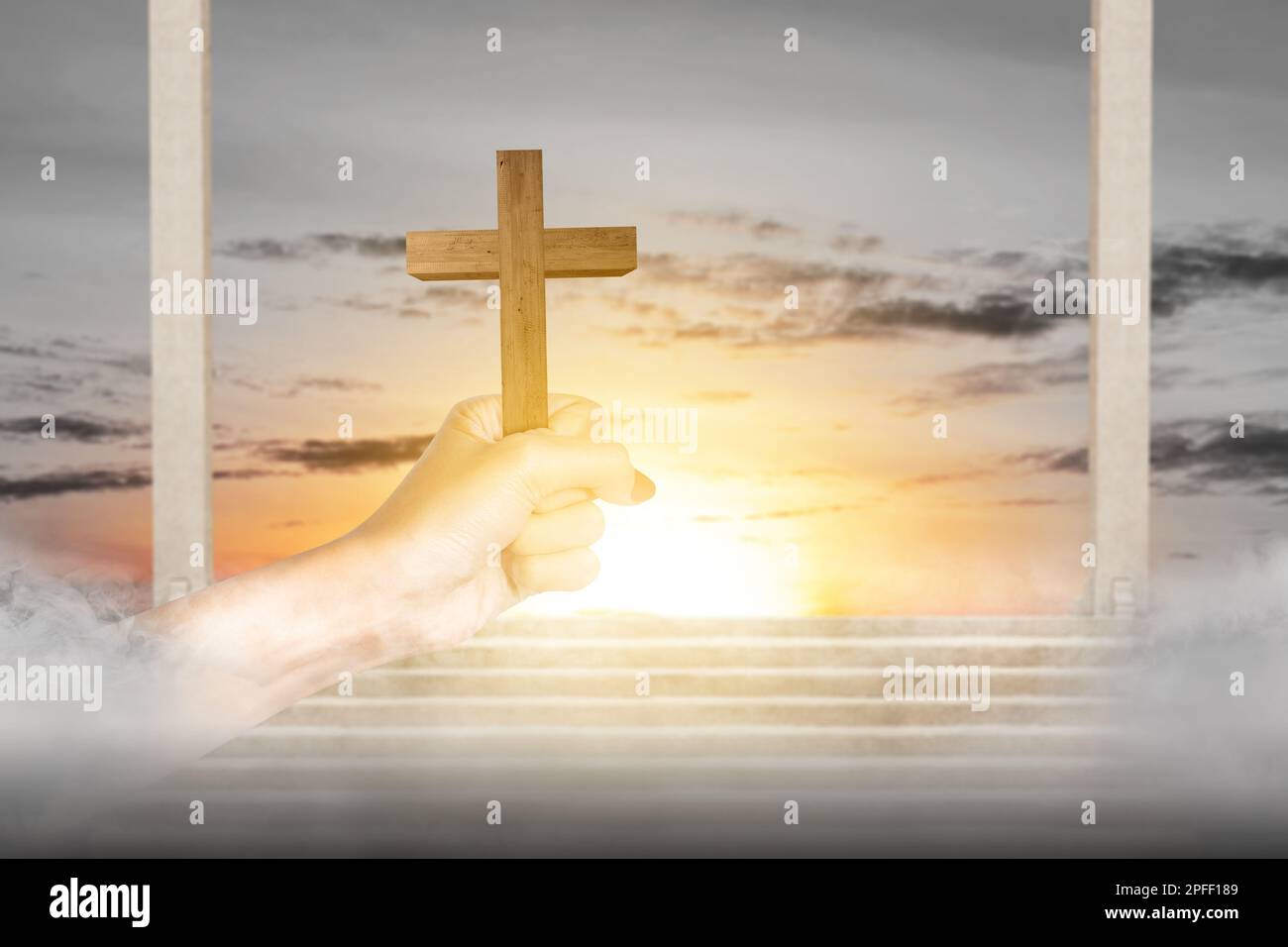 Human hand holding Christian cross with sunset sky background Stock ...