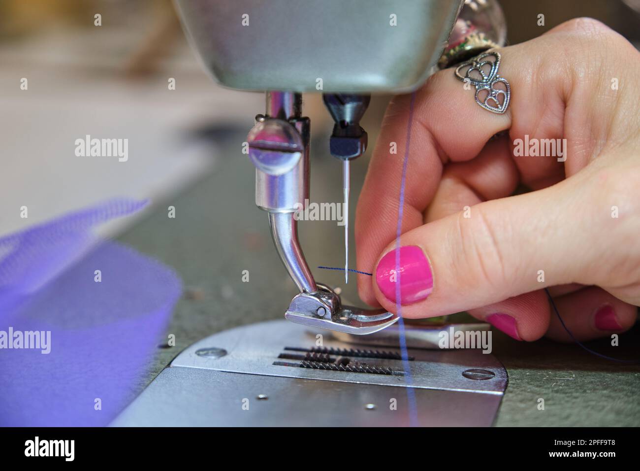 Close up of a tailor hand threading sewing machine Stock Photo Alamy