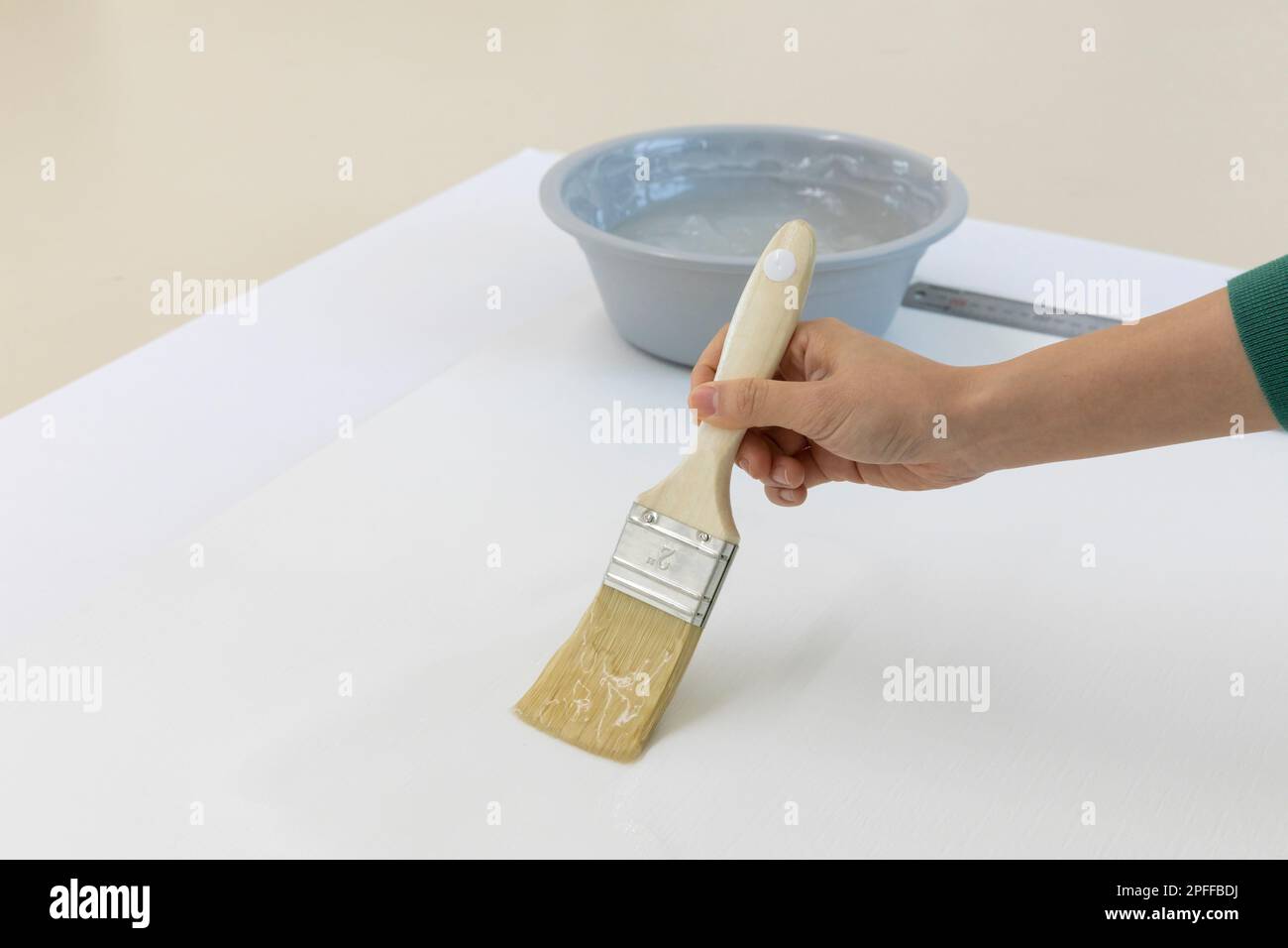 DIY interior hand motion, closeup apply paste to wallpaper Stock Photo