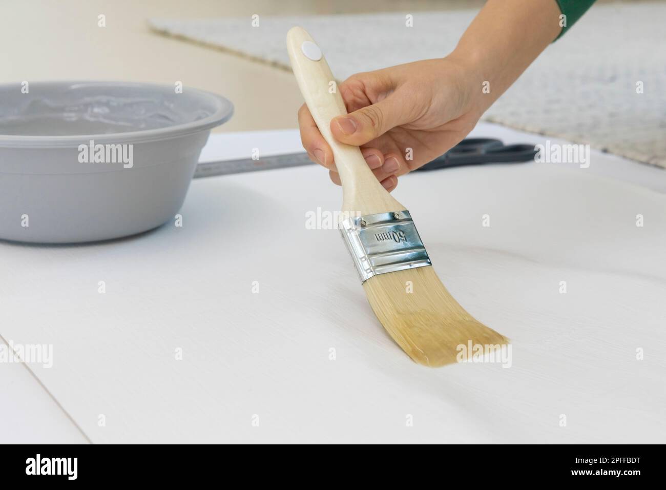 DIY interior hand motion, closeup apply paste to wallpaper Stock Photo