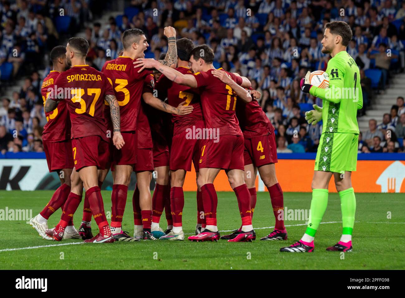 Players of AS Roma celebrate scoring while players of Real Sociedad claim hands during UEFA Europa League round of 16, second leg match between Real Sociedad and AS Roma at Reale Arena. Donostia (Spain). March 16, 2023. (Gari Garaialde / Bostok Photo). Stock Photo