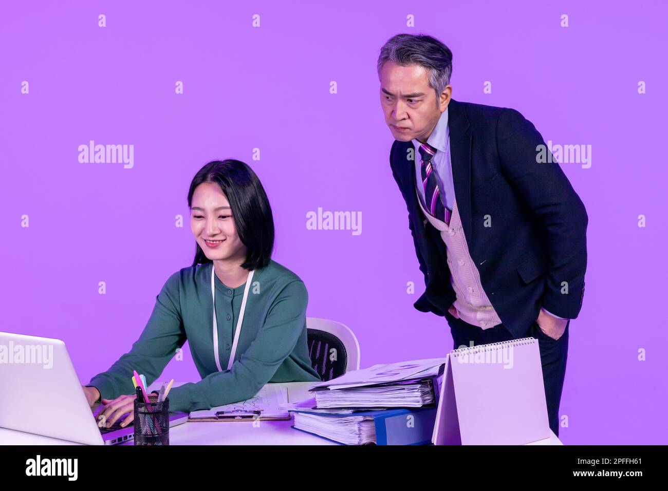 relationship and conflict between younger and older workers concept, Korean Asian young woman and manager level older man Stock Photo