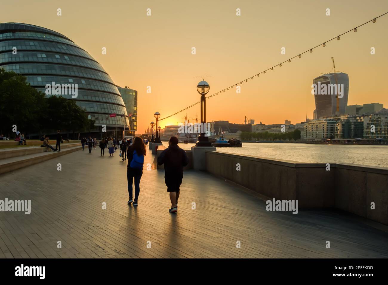 London, United Kingdom - May 23, 2018 : People enjoy the amazing orange sunset next to the river Thames in London Uk Stock Photo
