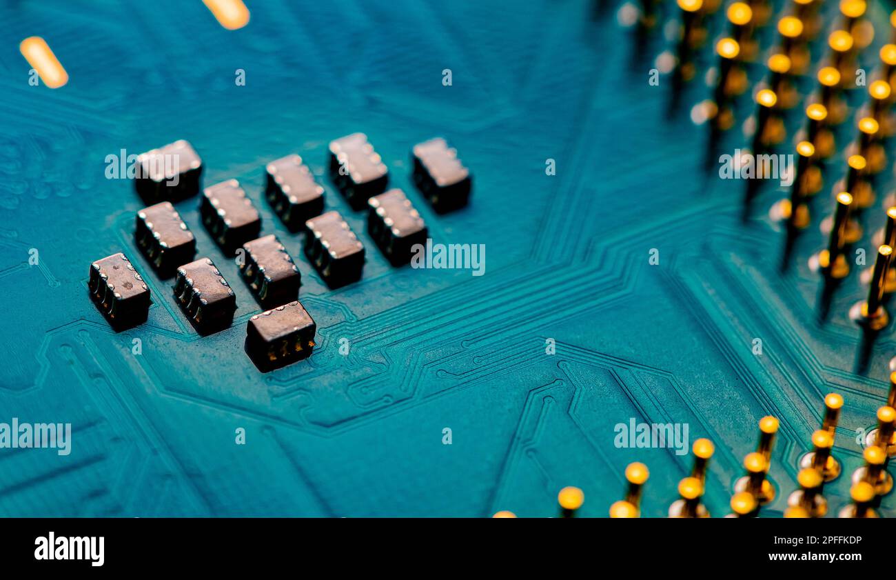 Macro Close up of microchips and pins on Main CPU PC processor circuit board. Stock Photo