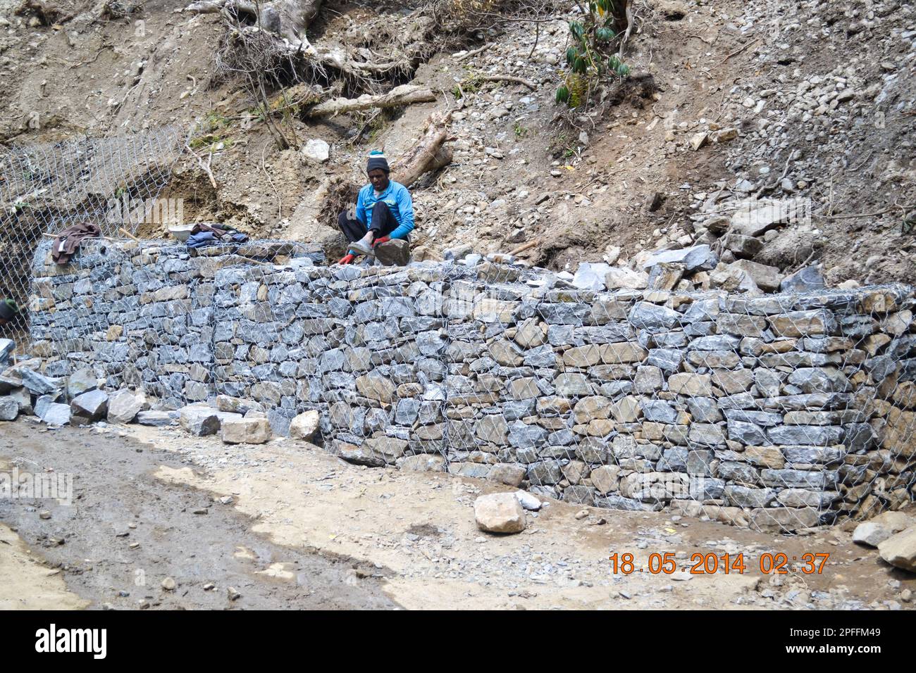 Rudarprayag, Uttarakhand, India, May 18 2014, A labors building safety wall near the landslide zone in Kedarnath. Kedarnath was devastated on June 201 Stock Photo
