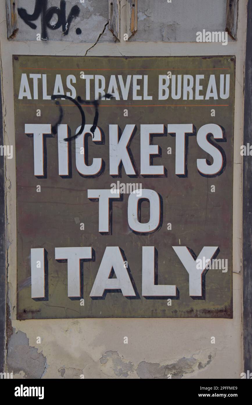 Retro sign offering tickets to Italy at the front of the closed and  derelict Atlas Travel Bureau in Patras, Greece, opposite Patras railway  station Stock Photo - Alamy
