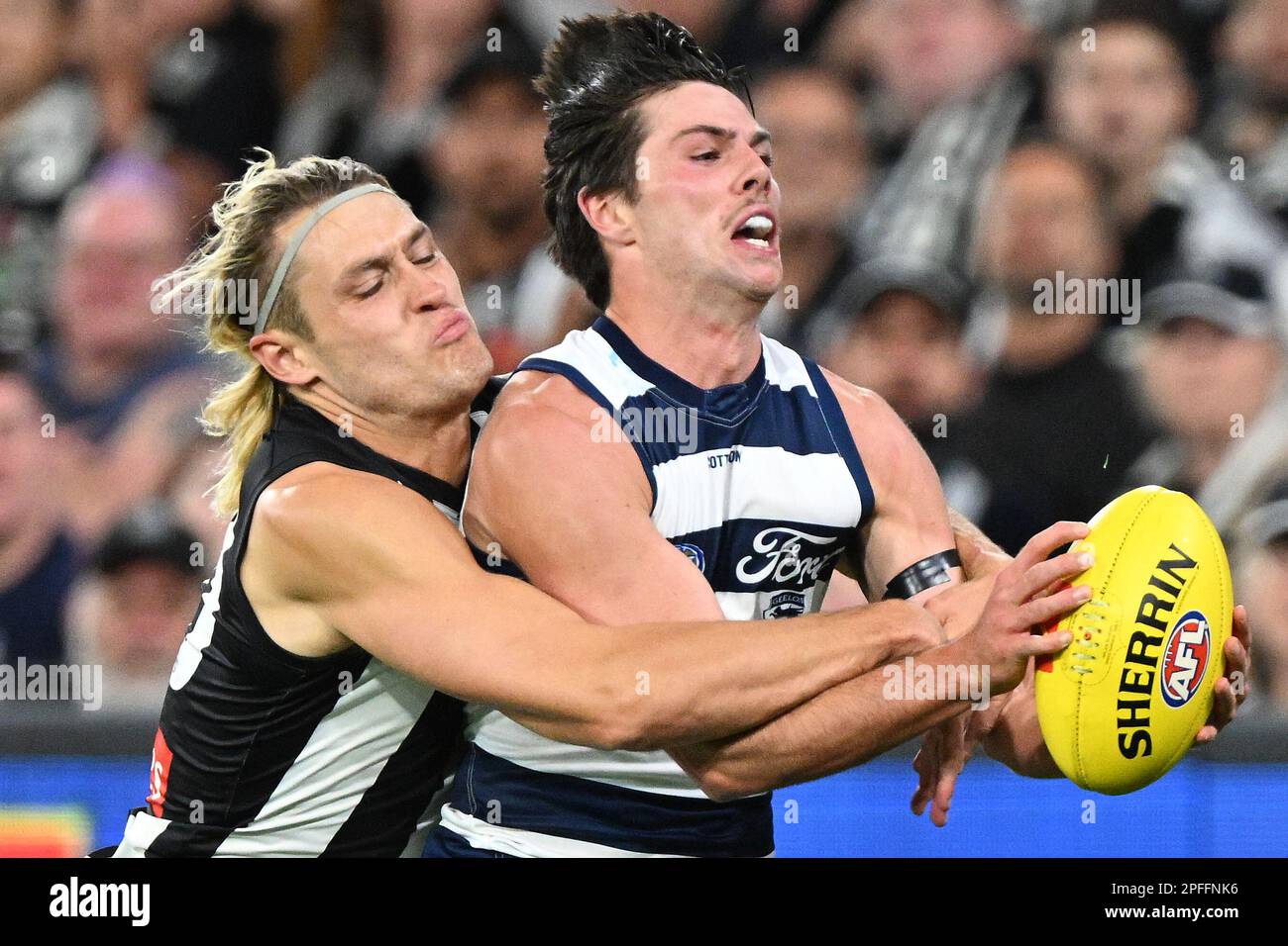 Darcy Moore of Collingwood (left) tackles Oliver Henry of Geelong