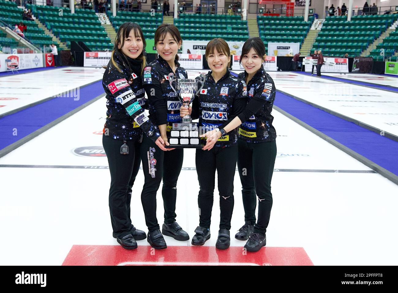 Team Fujisawa pose with the trophy after their victory in the final of the Grand Slam of Curling