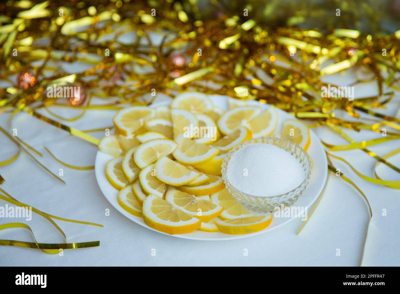 Lemons and sugar on the plate an the table Stock Photo
