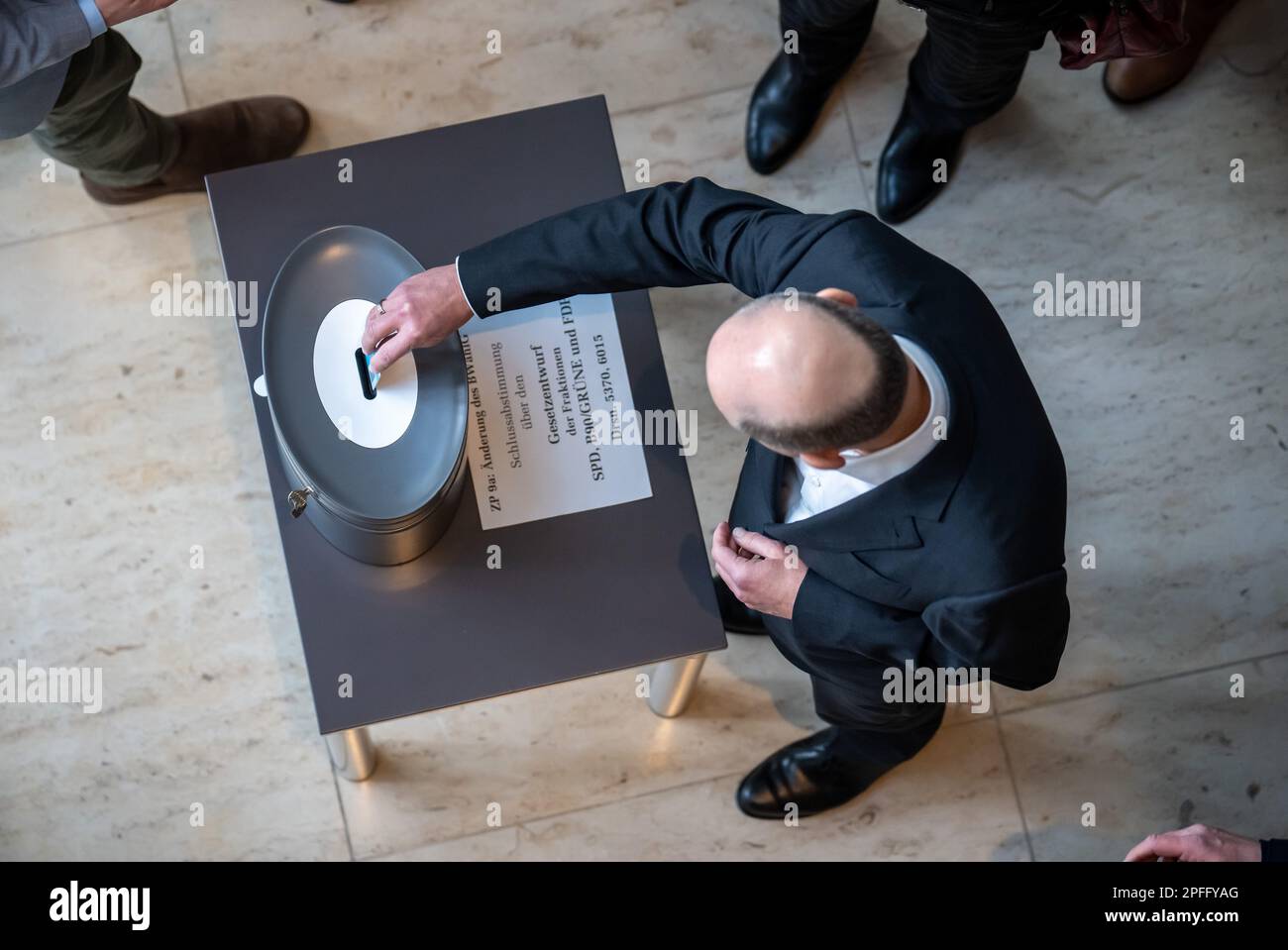 Berlin, Germany. 17th Mar, 2023. Chancellor Olaf Scholz (SPD), throws in his voting card during the roll call vote in the Bundestag. The vote on the reform of the Federal Election Act is intended to reduce the size of parliament after the next federal election. Credit: Michael Kappeler/dpa/Alamy Live News Stock Photo