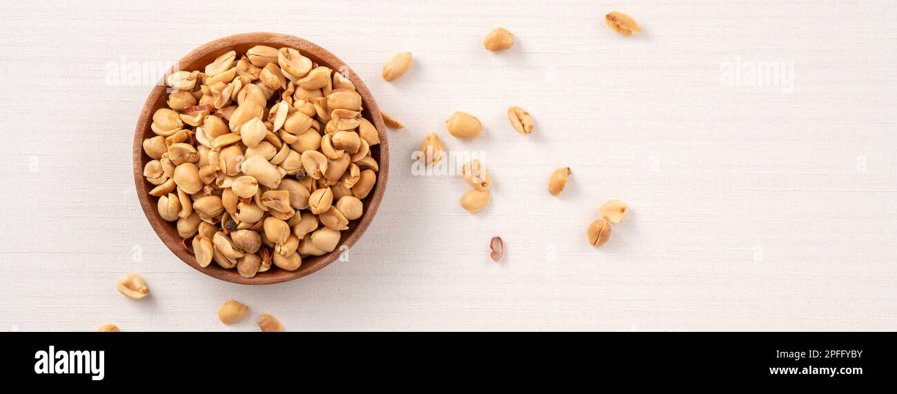 Spicy flavored peanut kernel in a bowl on white table background. Stock Photo
