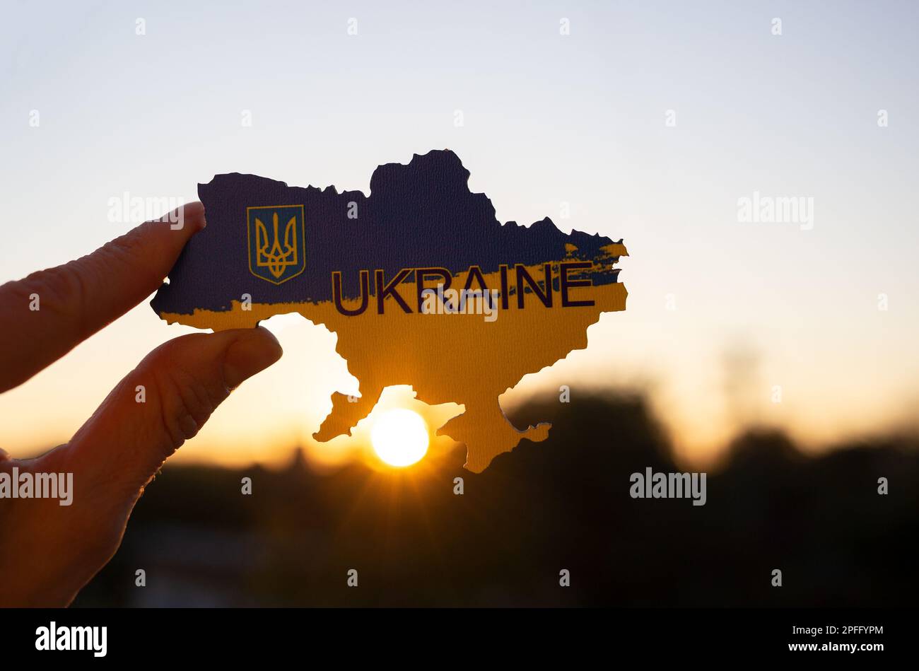 silhouette image of territory of the state of Ukraine and setting sun. soft focus, backlight. Stop the war in Ukraine, Love for Motherland, drawing at Stock Photo