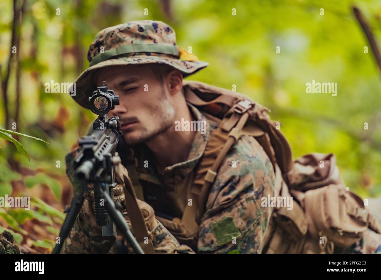 A modern warfare soldier on war duty in dense and dangerous forest ...