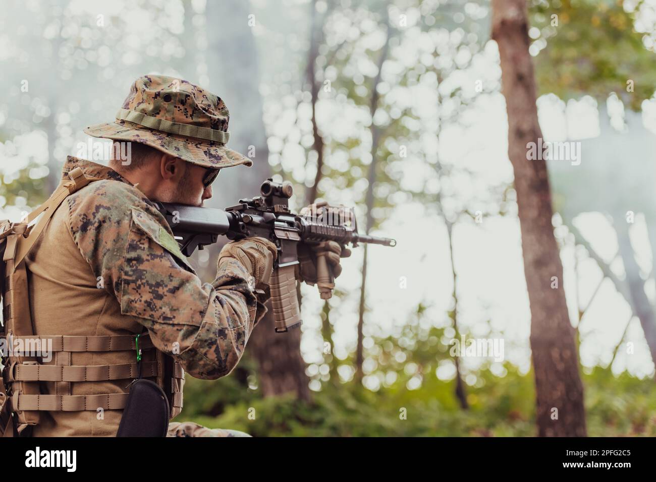A modern warfare soldier on war duty in dense and dangerous forest ...
