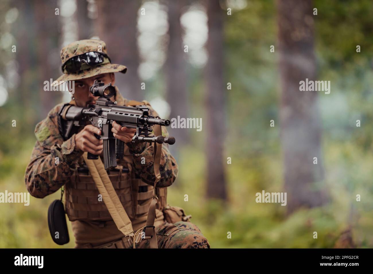 A modern warfare soldier on war duty in dense and dangerous forest ...