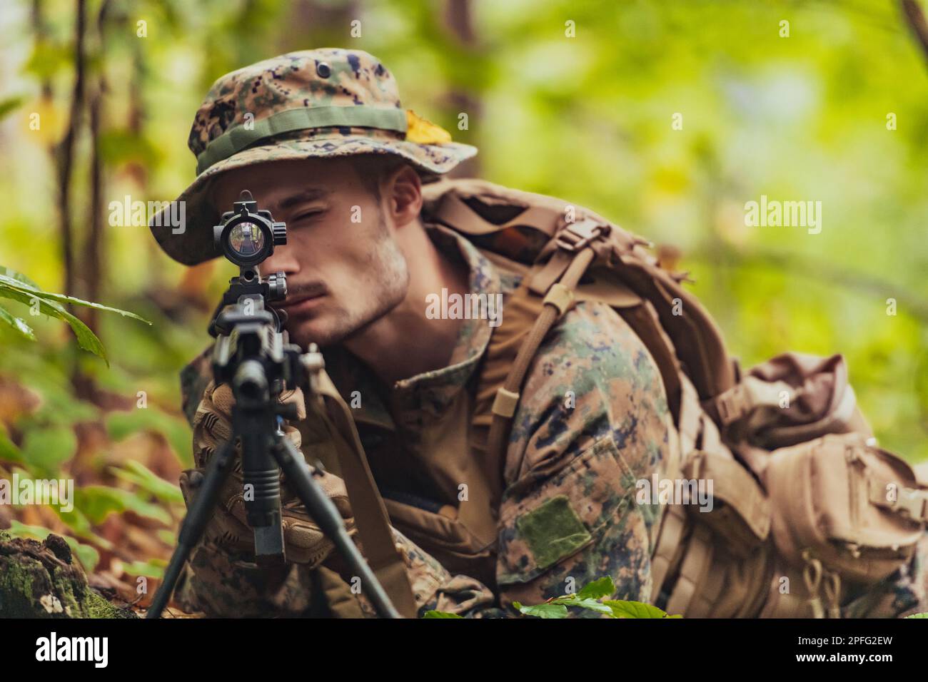 A modern warfare soldier on war duty in dense and dangerous forest ...