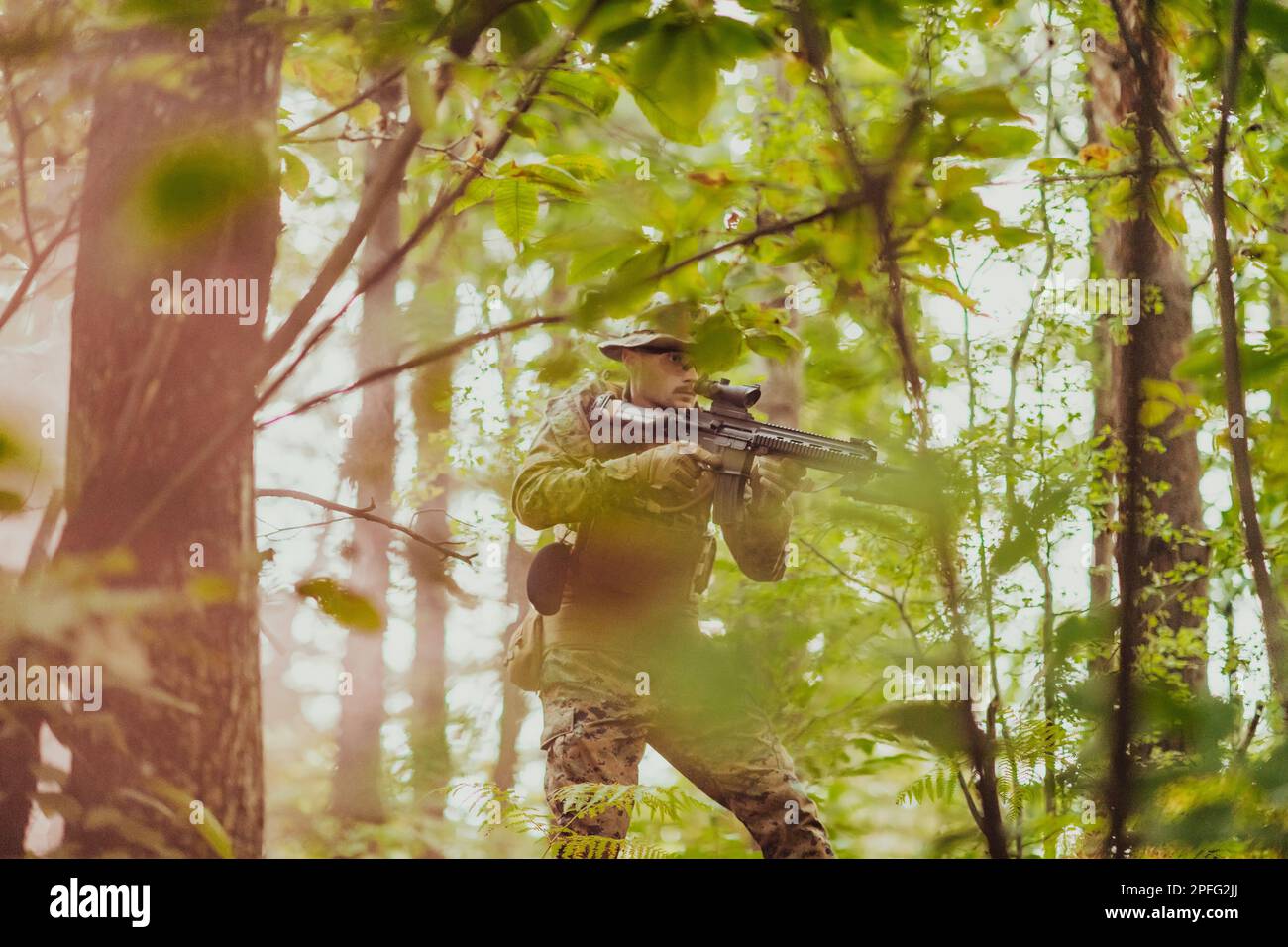 A modern warfare soldier on war duty in dense and dangerous forest ...